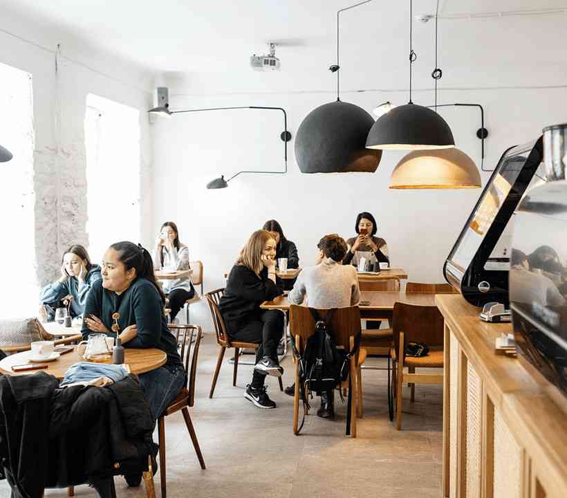 A modern cafeteria offering a variety of food options in a spacious dining area